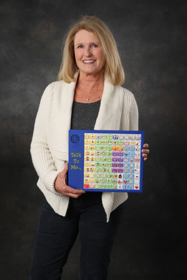 Sydney Birr holding the Talk To Me 100 device